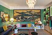 Seating and large artwork in lounge with green walls