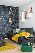 Grey sofa and wallpaper with animal motifs