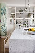 Kitchen counter with marble cover and bar stool