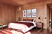 Double bed in bedroom with wood panelling