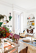White living room with colorful accessories in a mix of styles