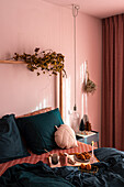 Breakfast in bed in bedroom with pink wall