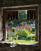 View of garden through rustic barn window