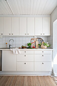 Plain white kitchen with summery decorations