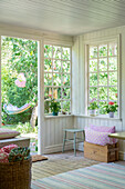 Summery conservatory with lattice windows in Swedish style