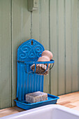Vintage-style blue metal soap holder with brush and soap