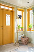 Hallway with yellow front door and wooden panelling