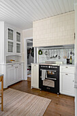 Gas cooker and sideboard in pale kitchen