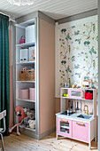 Play kitchen and shelf in girl's bedroom