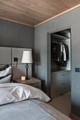 Bedroom with grey walls and walk-in wardrobe