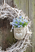 Forget-me-not in a fabric bag on a wreath