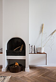 Arched open fireplace in minimalist, slow living interior