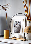 Vases and photo on low sideboard