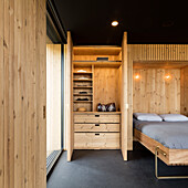 Foldaway bedstead and storage space in a pavilion house
