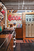 Wooden kitchen base units and retro metal cabinets in eclectic interior