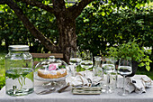 Coffee table with cake under apple tree
