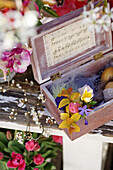 Posy, Easter eggs and feathers in a wooden box