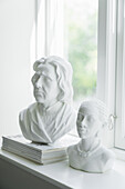 Female and male busts on windowsill
