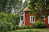 Swedish wooden house in lush garden