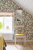 Floral wallpaper in bedroom with sloping ceiling