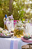 Festively set table outdoors decorated with flowering branch