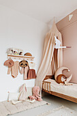 Girls' room with wooden bed and canopy in nude shades