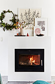 Burning fireplace and decorative design on fireplace console