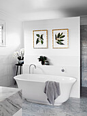 Bathroom with freestanding bathtub and marble tiles