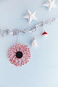 DIY Christmas decoration with larch, candy canes and tree pendants