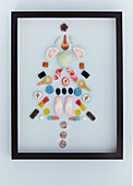 Stylised Christmas tree made of sweets in a black frame