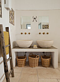 Brick washstand with two top basins, ladder as towel rail in Mediterranean bathroom