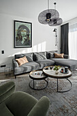 Grey corner sofa, coffee table set and armchair in living room