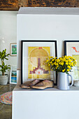 Shelf with flowers, antique shoe lasts and modern posters