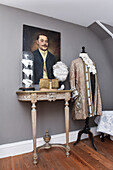 Baroque costumes and accessories on dressmaker's dummy and console table