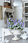 Blue bellflowers in an amphora and Shabby Chic decoration