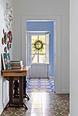 Hallway with patterned floor tiles and decoration on the wall