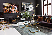 Living room with black walls and gold-colored furniture accents
