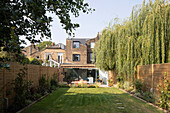 View over lawn in garden to old brick house