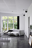 Modernes Sofa im minimalistischen Wohnzimmer in Grau und Weiß