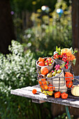 Colourful potpourri of autumn fruits and flowers