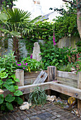 Wildly planted beds made of wooden planks in a courtyard garden