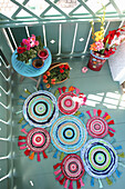 DIY patchwork rug made of colourful fabric scraps on balcony