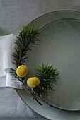 Winter plate decoration of dried craspedias and conifer twigs