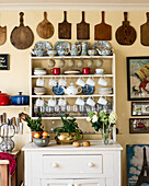 White sideboard with crockery and vintage kitchen utensils