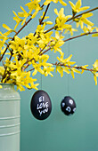 Hand-painted Easter eggs hanging from Forsythia twigs