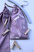 Purple cloth bag with clothespins