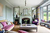 Living room with fireplace, seating and view of the yard