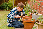 Boy planting and sowing seeds