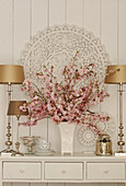 Branches of cherry blossom in vase and silver ornaments