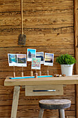 DIY photo holder made of cork and potted herbs on wooden table
